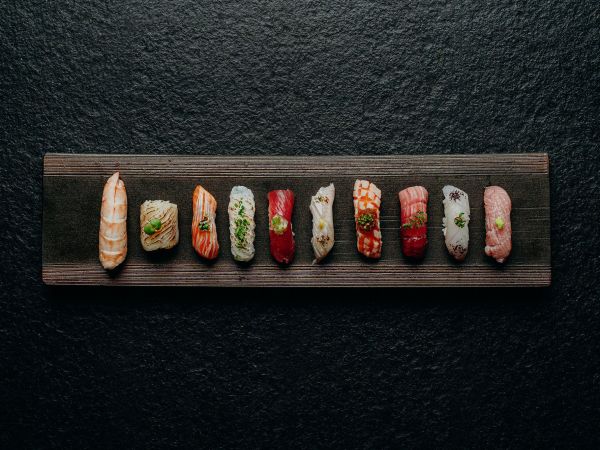 A row of sushi on a black background at Sokyo in The Star Brisbane