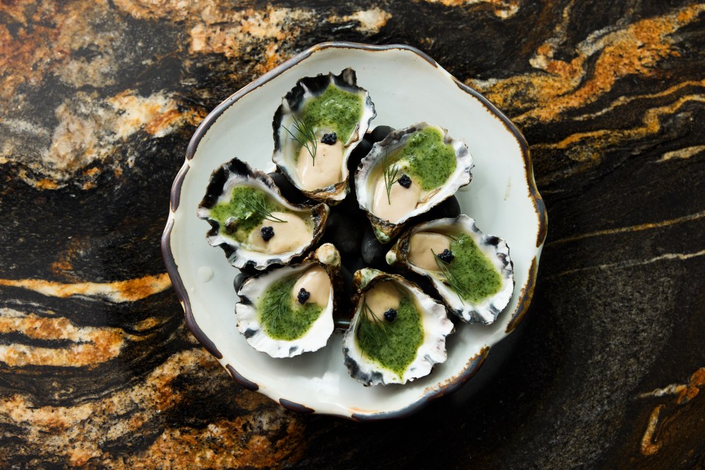 Annamese Sydney Rock oyster with nuoc cham haisan dressing, green chili, lime, and black caviar