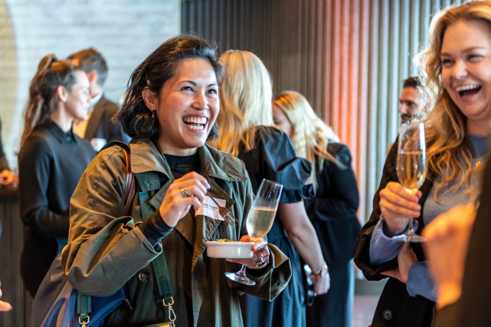 Women talking and eating canapes at a previous International Women's Day event. 