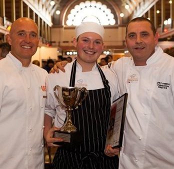 L-R: 2016 competitor Stephen Blant presents his dishes to the judging panel – Head Judge John McFadden, Sam Burke and Karen Doyle.