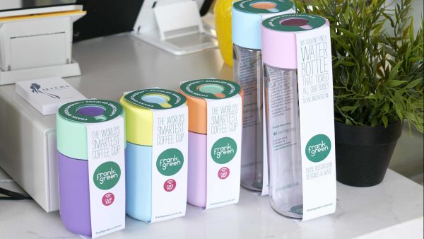 A selection of frank green Smart Cups and Bottles at a cafe register. Sales have risen following the abc's War on Waste.